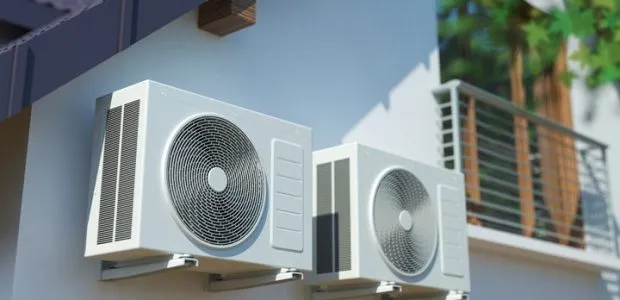 Air conditioning compressor units at the outdoor wall of a house